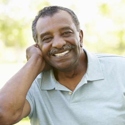 Man with healthy smile after dental crown restoration