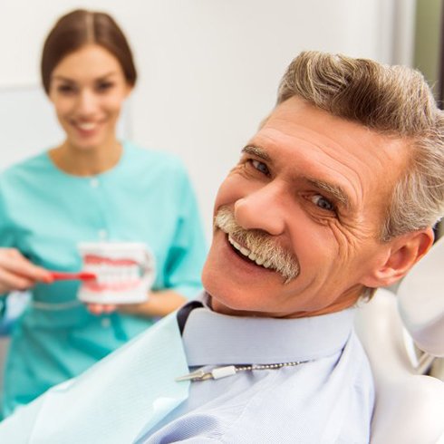 man at a consultation with his denture dentist in Brecksville 