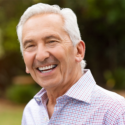 Man sharing healthy smile after dental bridge restoration