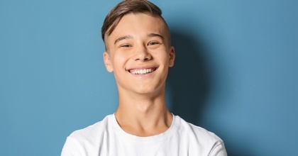 Young man with healthy smile after Invisalign clear braces